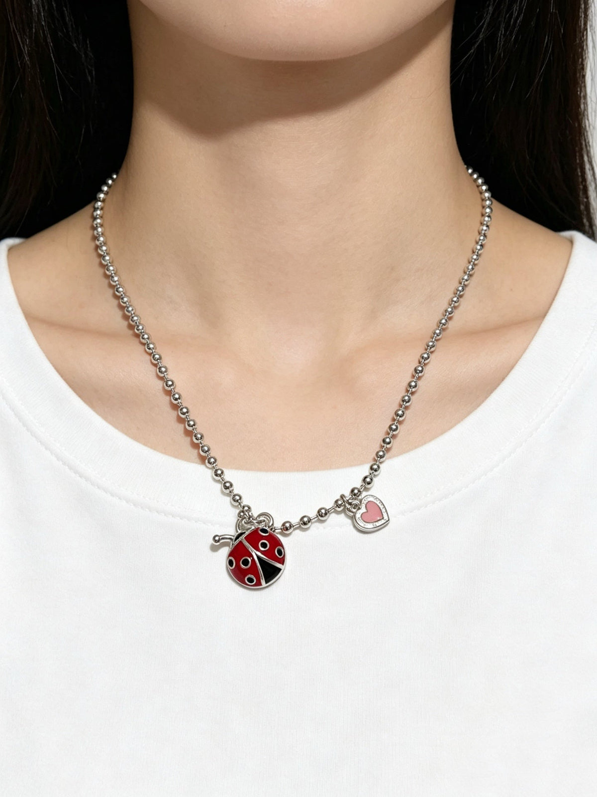 Martin Graham pendant necklace in polished metal-tone – side detail