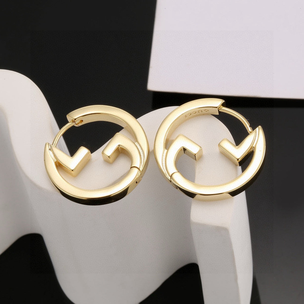 Martin Graham stud earrings in polished metal-tone – close-up detail
