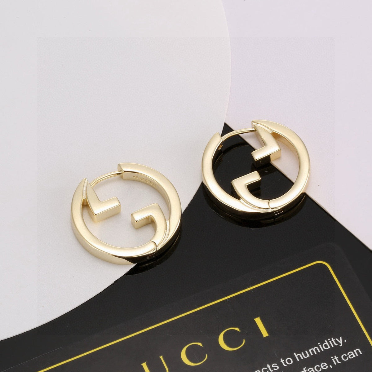 Martin Graham stud earrings in polished metal-tone – front product view
