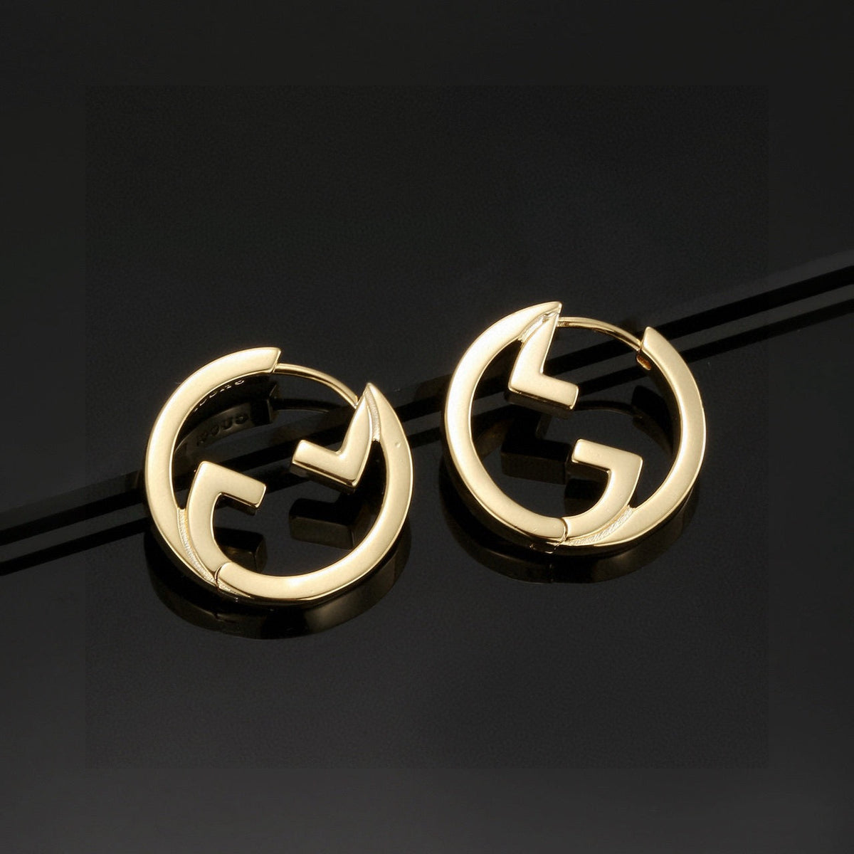 Martin Graham stud earrings in polished metal-tone – styled product view