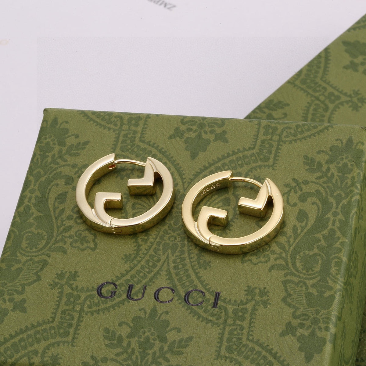 Martin Graham stud earrings in polished metal-tone – detail view