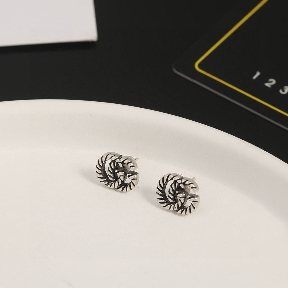 Martin Graham stud earrings in polished metal-tone – side detail