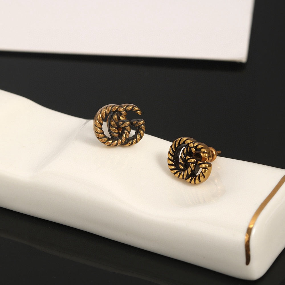 Martin Graham stud earrings in polished metal-tone – front product view