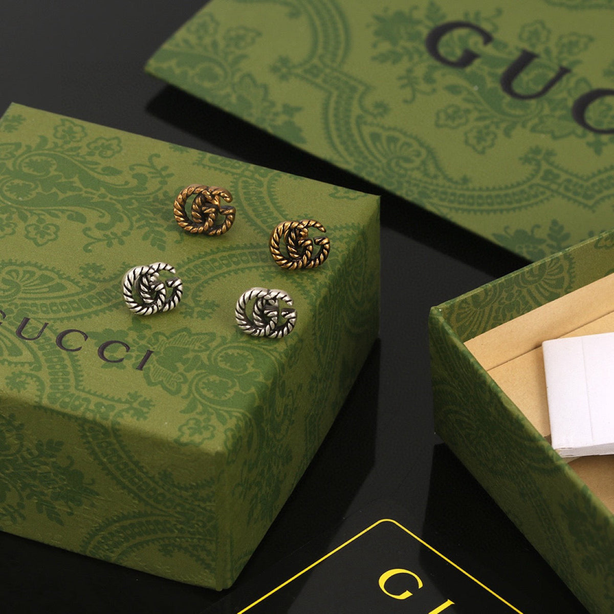 Martin Graham stud earrings in polished metal-tone – detail view