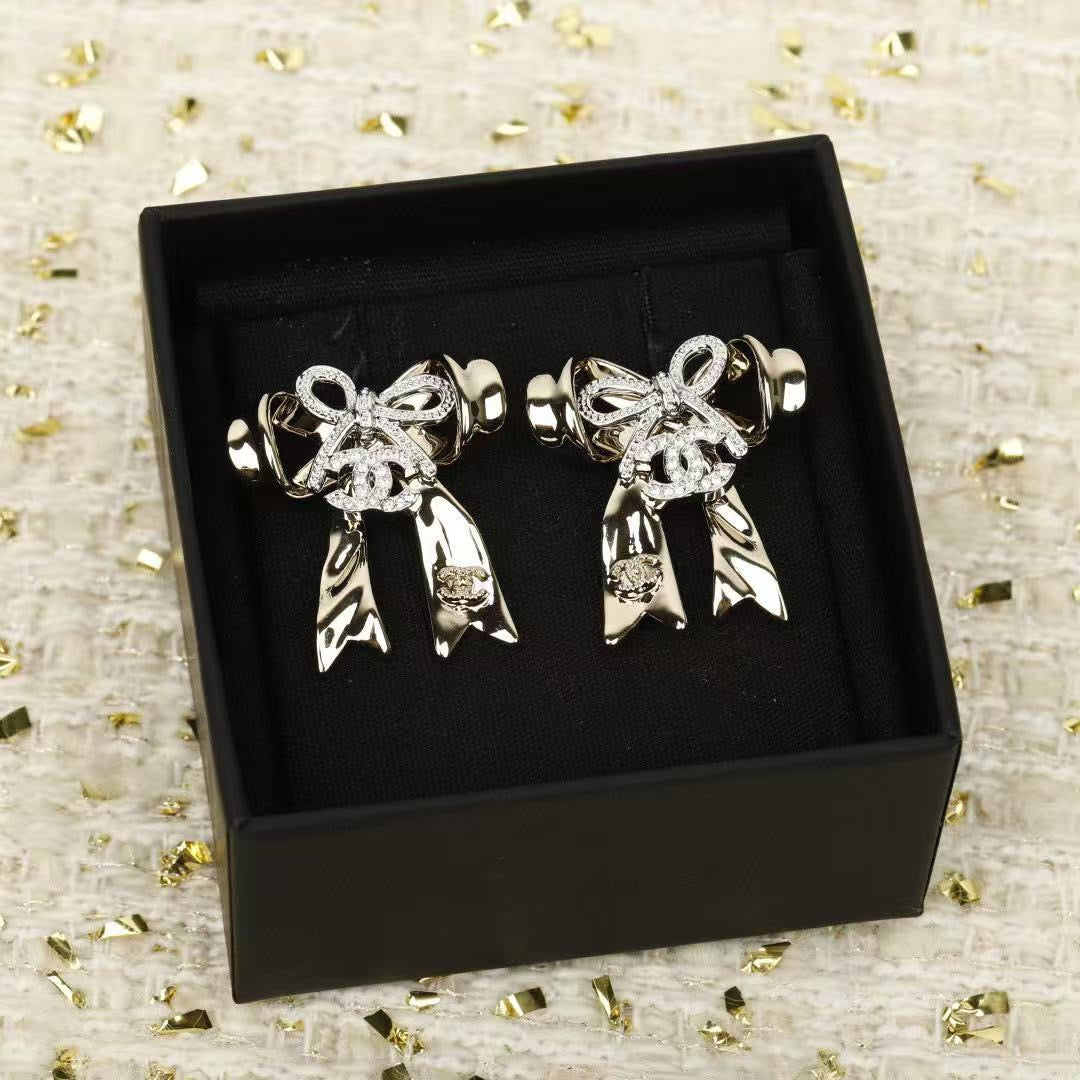 Martin Graham Bow stud earrings in polished metal-tone – front product view