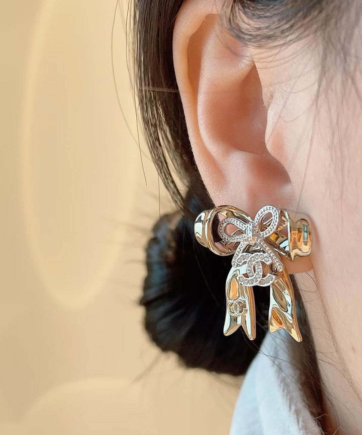 Martin Graham Bow stud earrings in polished metal-tone – styled product view
