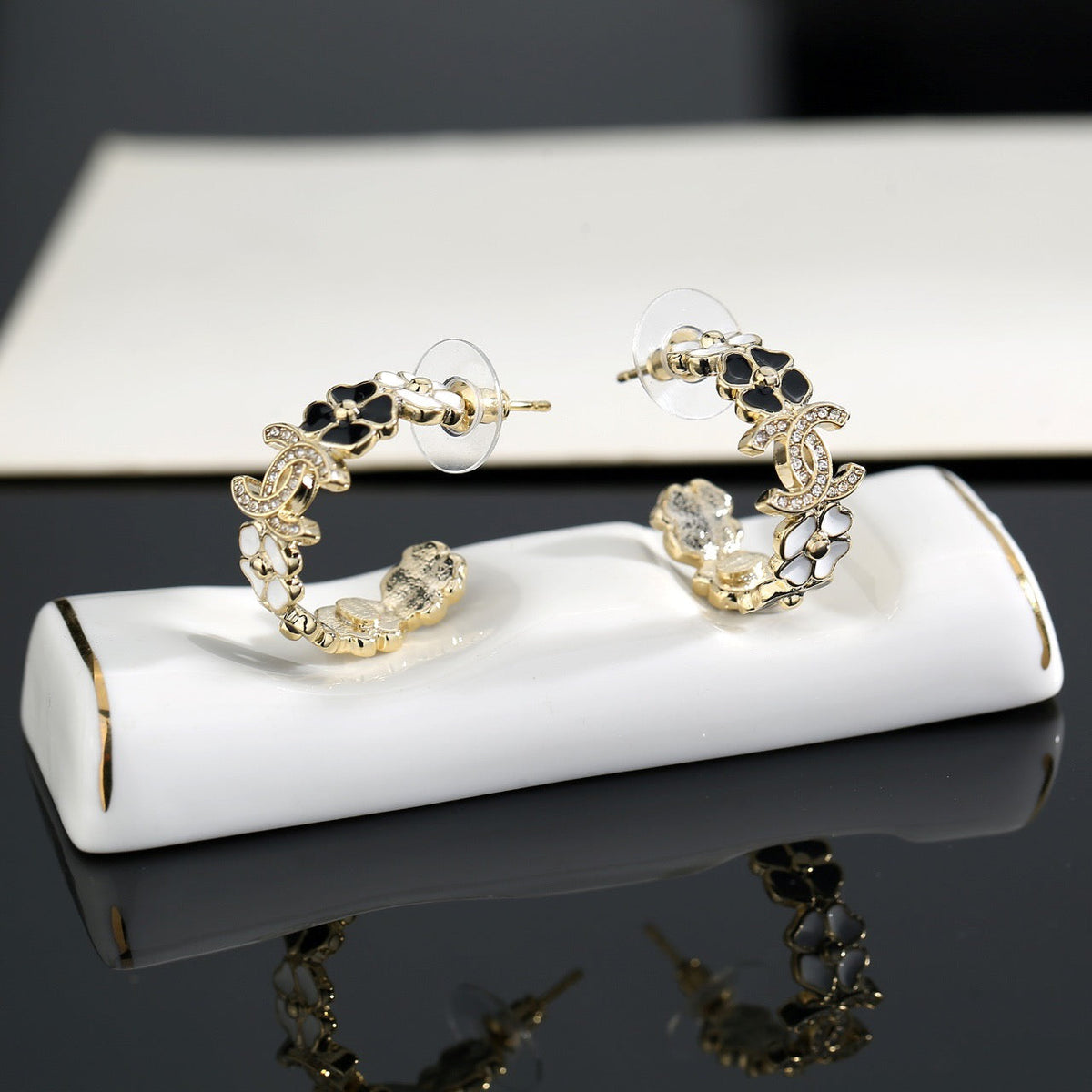 Martin Graham stud earrings in polished metal-tone – detail view