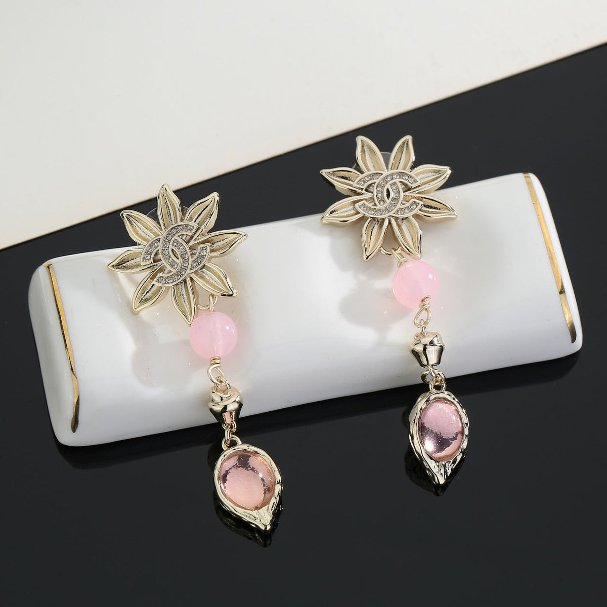 Martin Graham stud earrings in polished metal-tone – close-up detail
