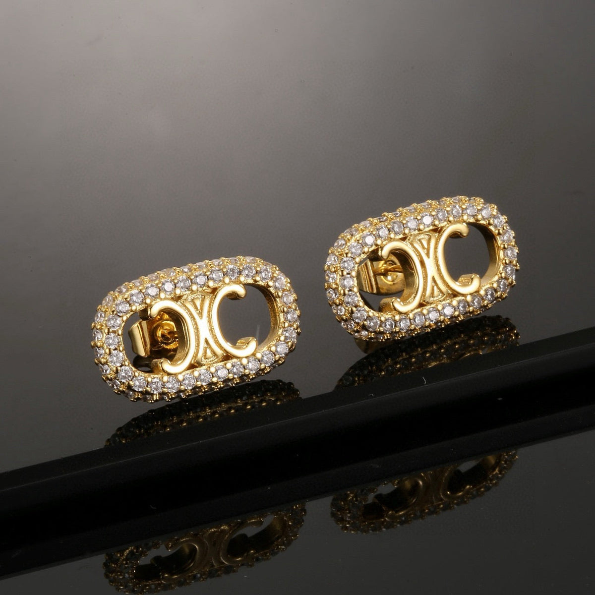 Martin Graham stud earrings in polished metal-tone – front view