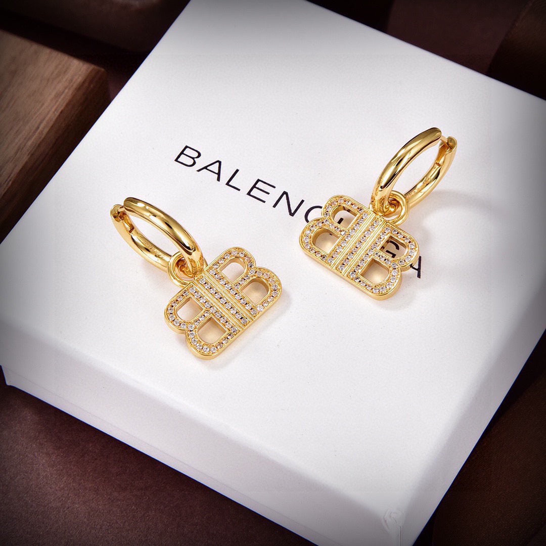 Martin Graham stud earrings in polished metal-tone – styled product view