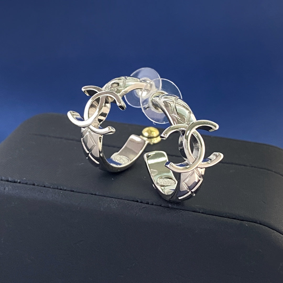 Martin Graham stud earrings in polished metal-tone – detail view
