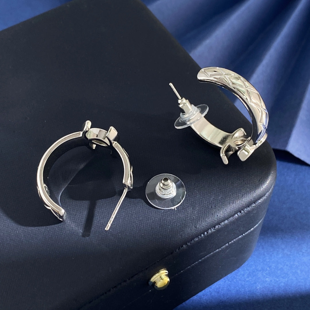 Martin Graham stud earrings in polished metal-tone – front product view