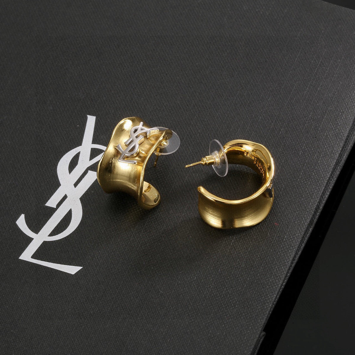 Martin Graham stud earrings in polished metal-tone – close-up detail