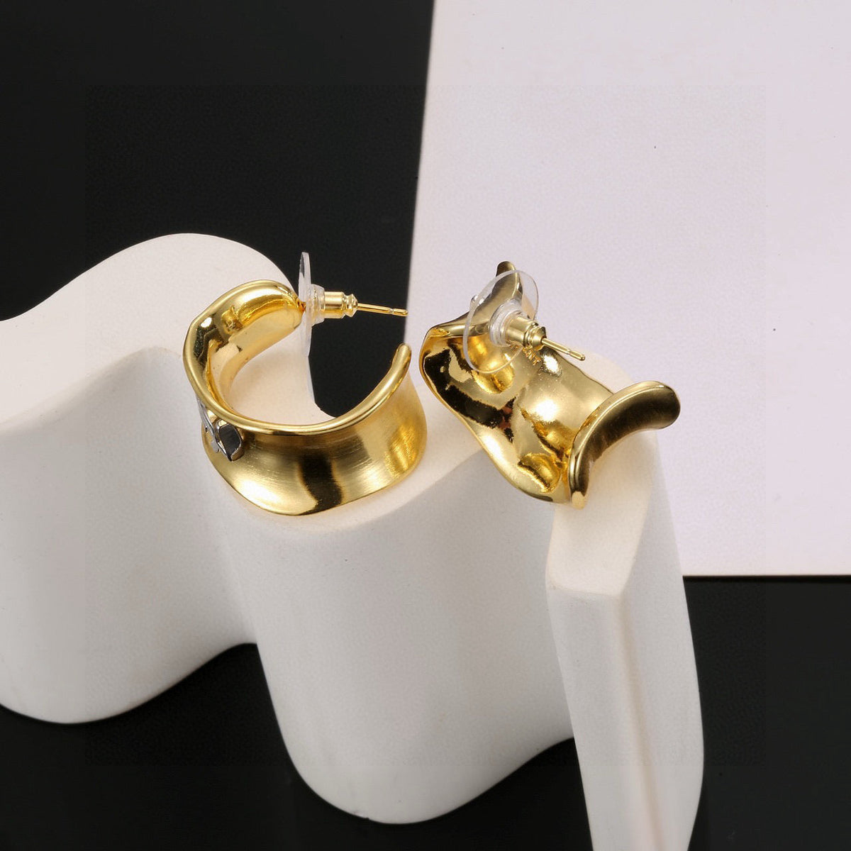 Martin Graham stud earrings in polished metal-tone – styled product view