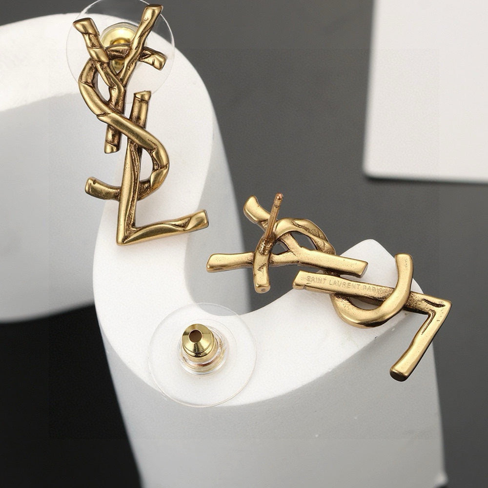 Martin Graham stud earrings in polished metal-tone – close-up detail