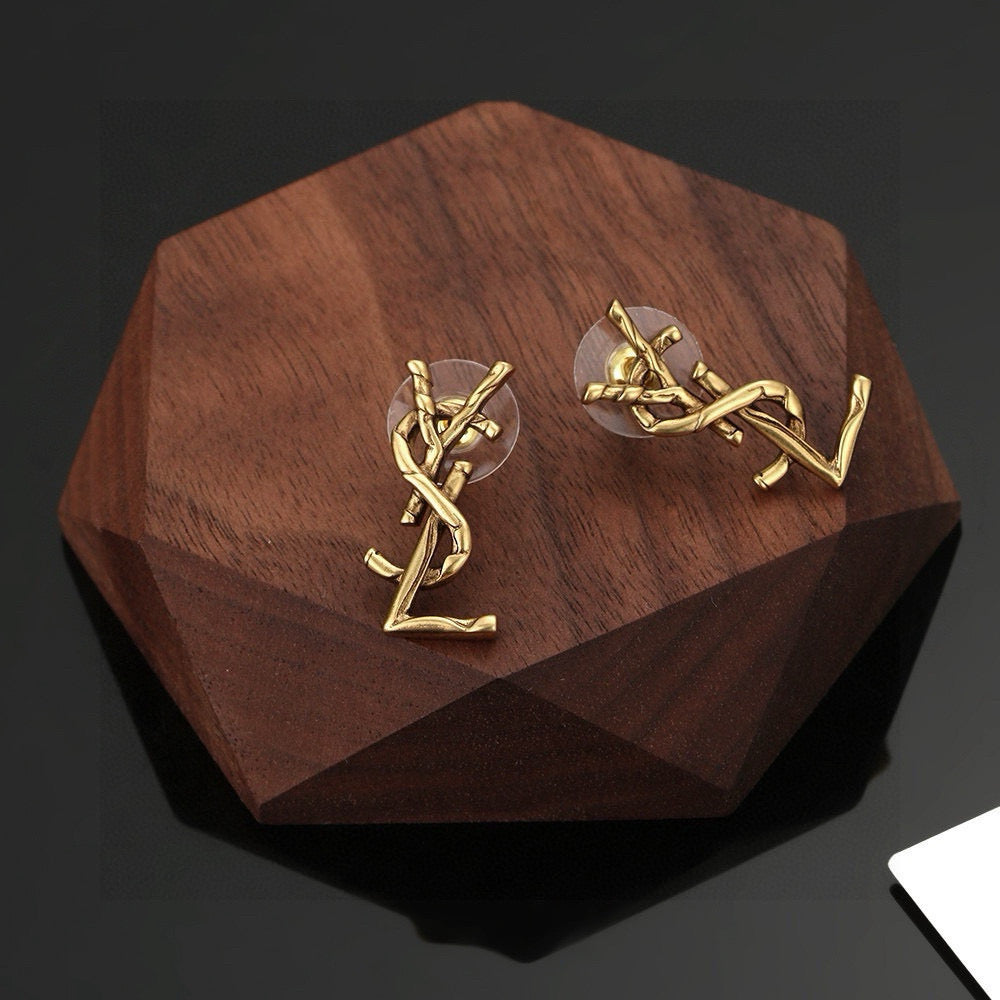 Martin Graham stud earrings in polished metal-tone – side detail