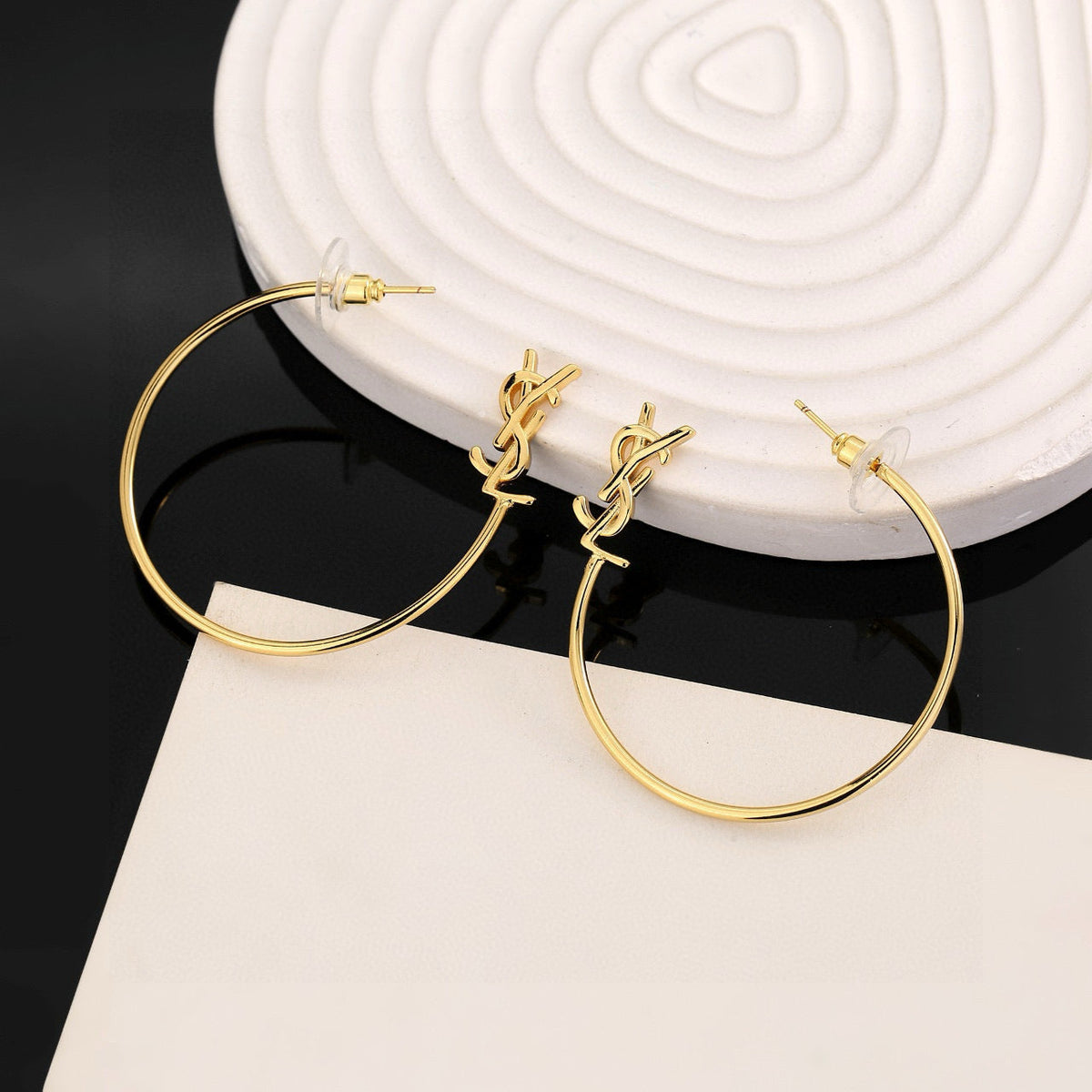 Martin Graham stud earrings in polished metal-tone – side detail