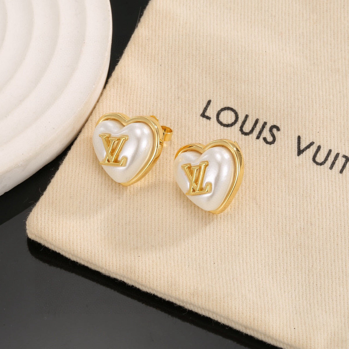 Martin Graham stud earrings in polished metal-tone – detail view