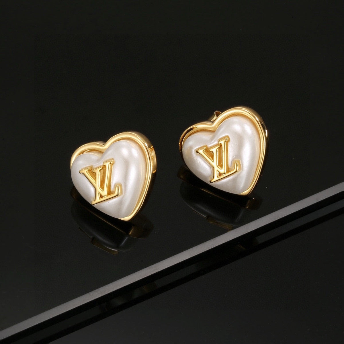 Martin Graham stud earrings in polished metal-tone – front product view