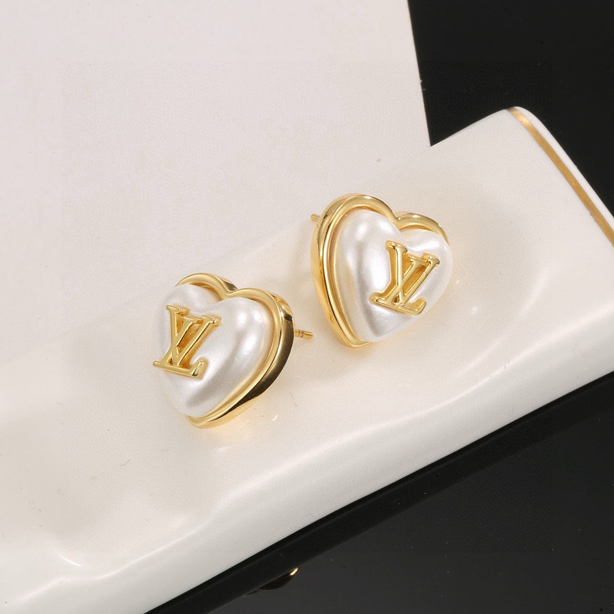 Martin Graham stud earrings in polished metal-tone – side detail