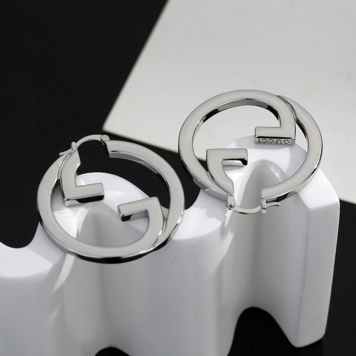 Martin Graham stud earrings in polished metal-tone – close-up detail