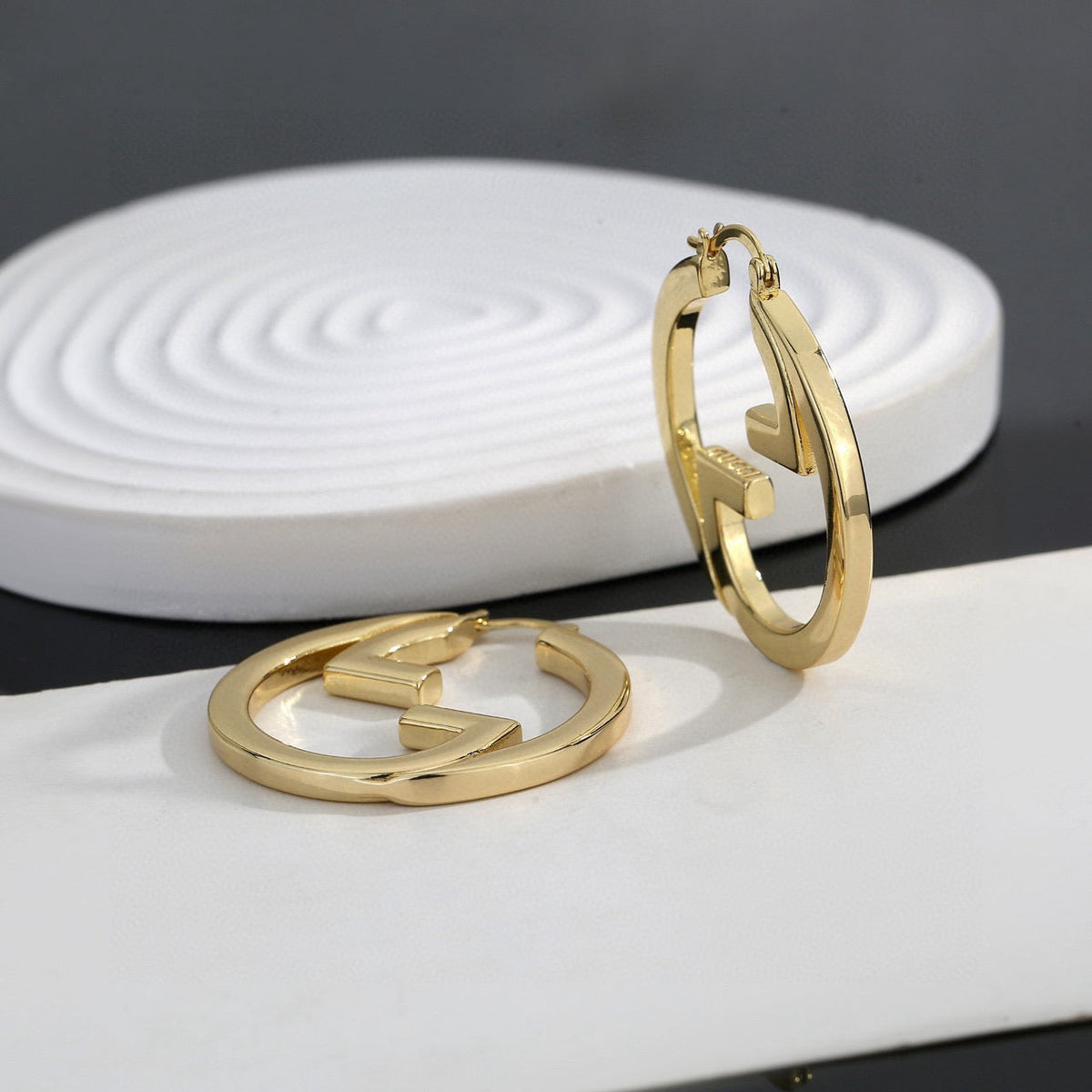 Martin Graham stud earrings in polished metal-tone – main product view