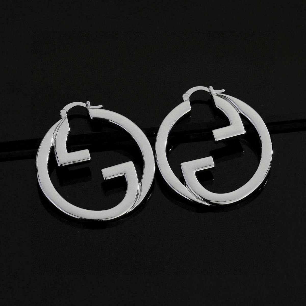 Martin Graham stud earrings in polished metal-tone – side detail