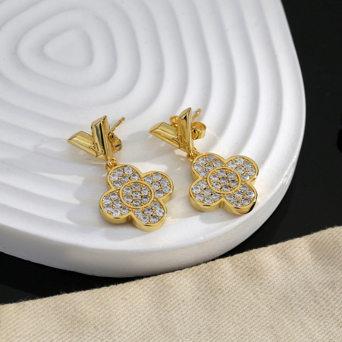 Martin Graham stud earrings in polished metal-tone – detail view