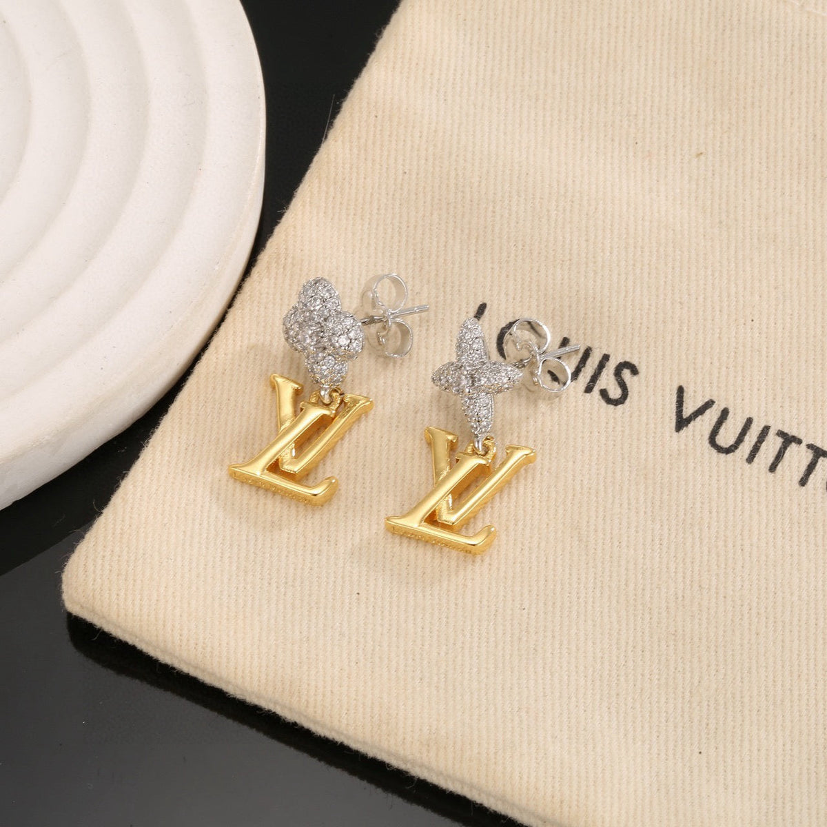 Martin Graham stud earrings in polished metal-tone – close-up detail