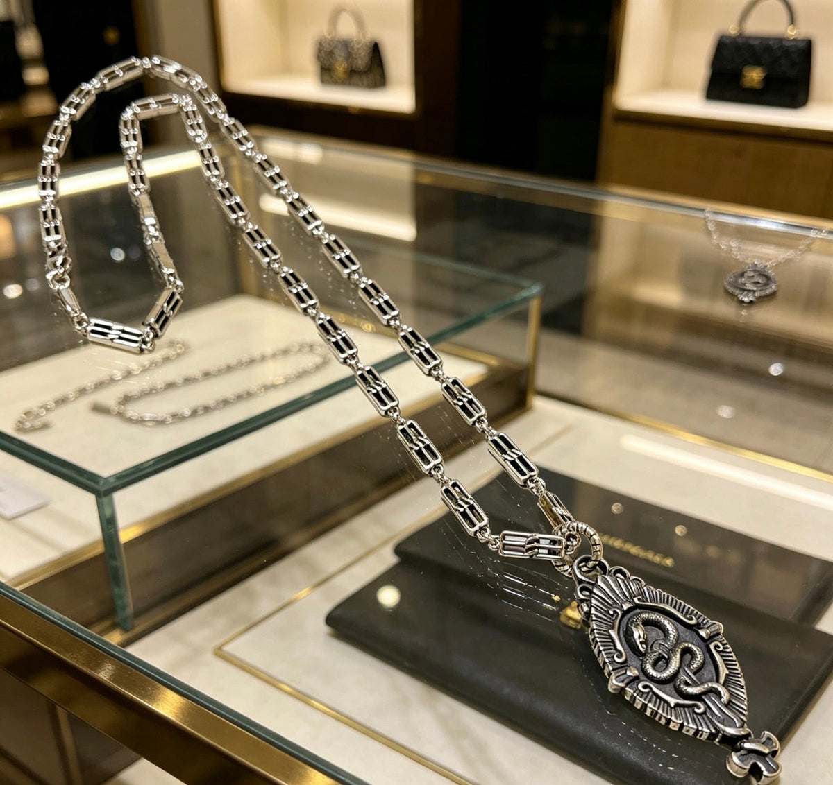Martin Graham pendant necklace in polished metal-tone – close-up detail
