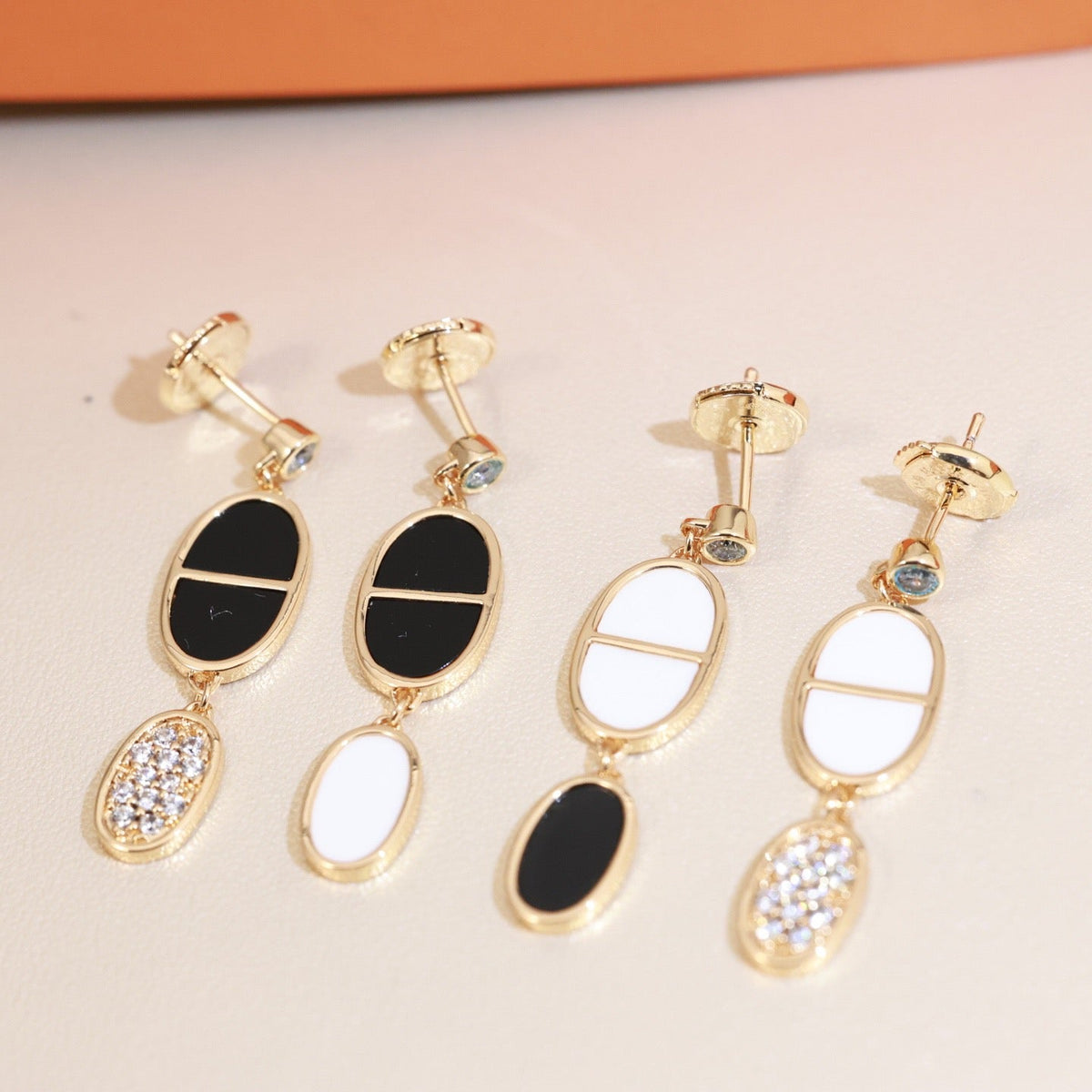 Martin Graham stud earrings in polished metal-tone – styled product view