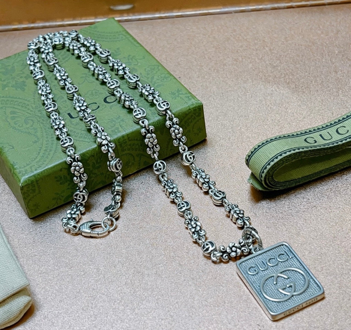 Martin Graham pendant necklace in polished metal-tone – close-up detail