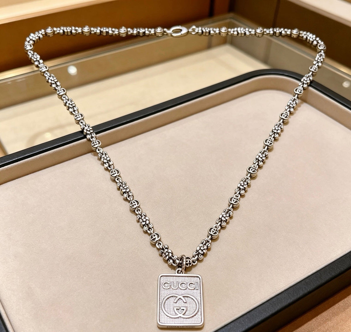 Martin Graham pendant necklace in polished metal-tone – side detail