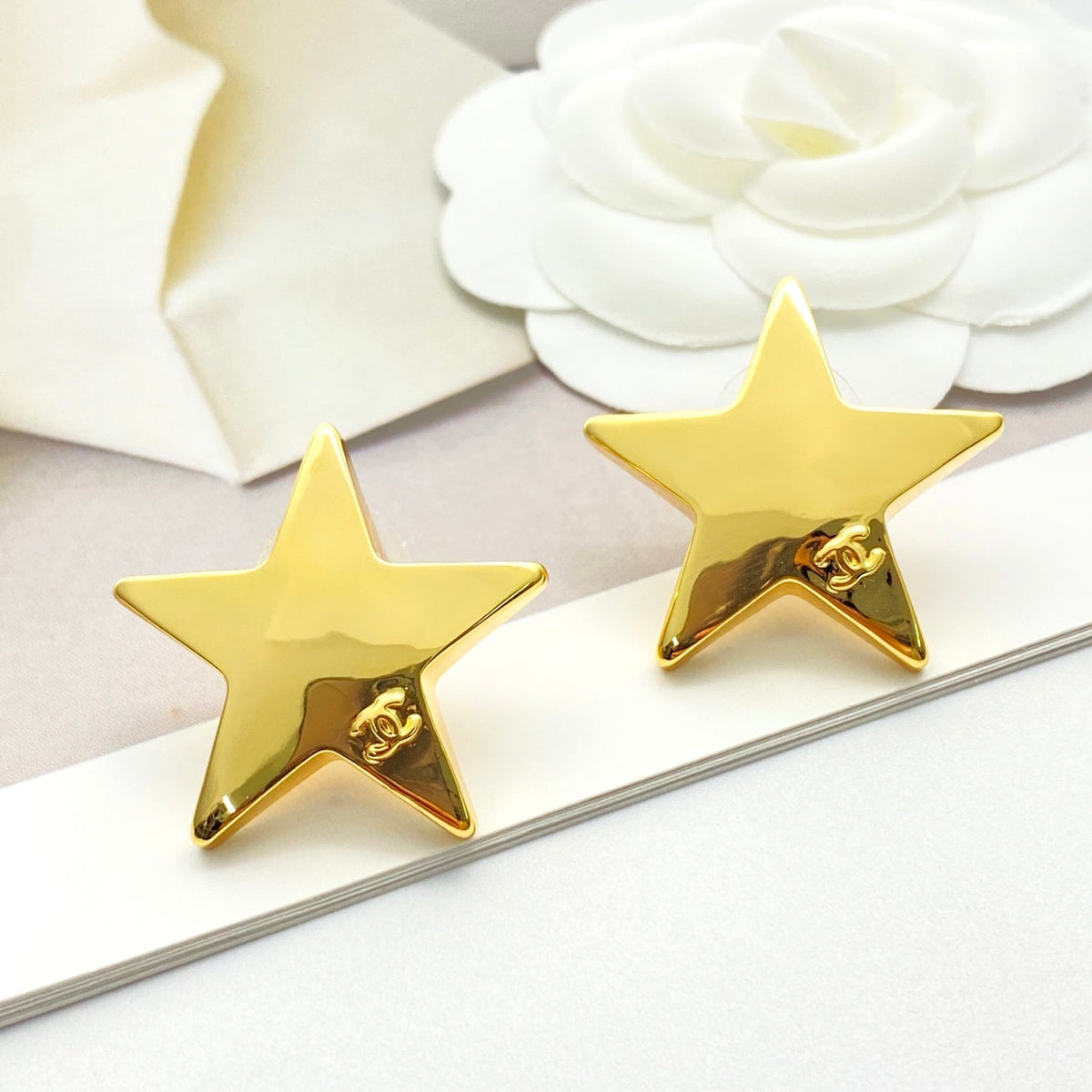 Martin Graham stud earrings in polished metal-tone – styled product view
