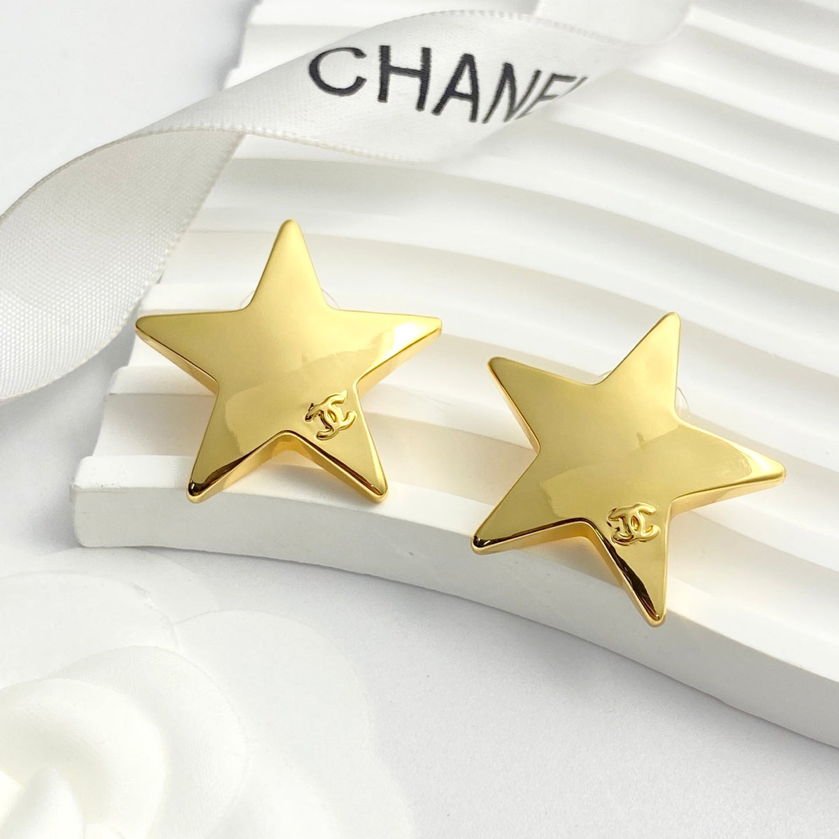 Martin Graham stud earrings in polished metal-tone – close-up detail