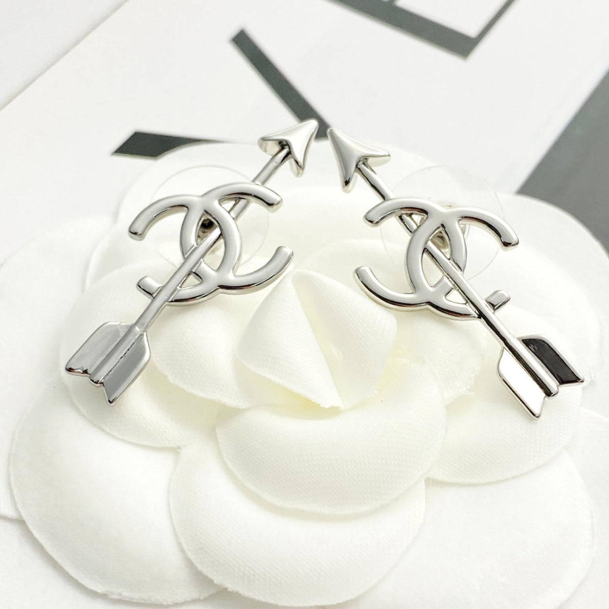 Martin Graham stud earrings in polished metal-tone – close-up detail