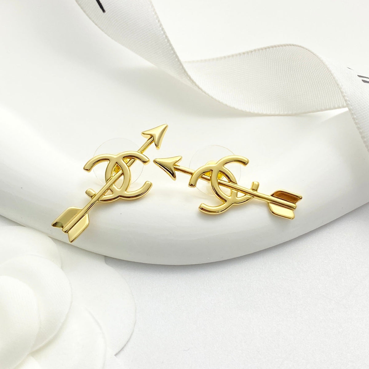 Martin Graham stud earrings in polished metal-tone – close-up detail