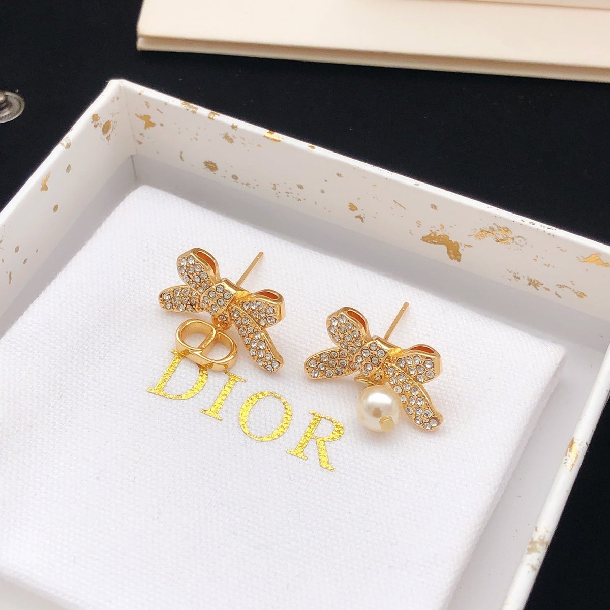 Martin Graham stud earrings in polished metal-tone – close-up detail