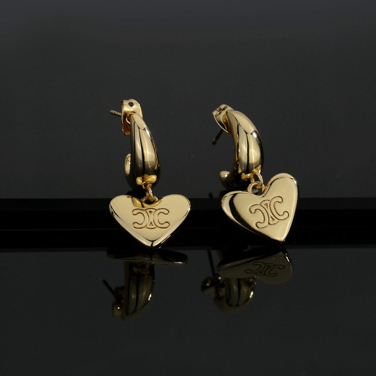Martin Graham stud earrings in polished metal-tone – detail view