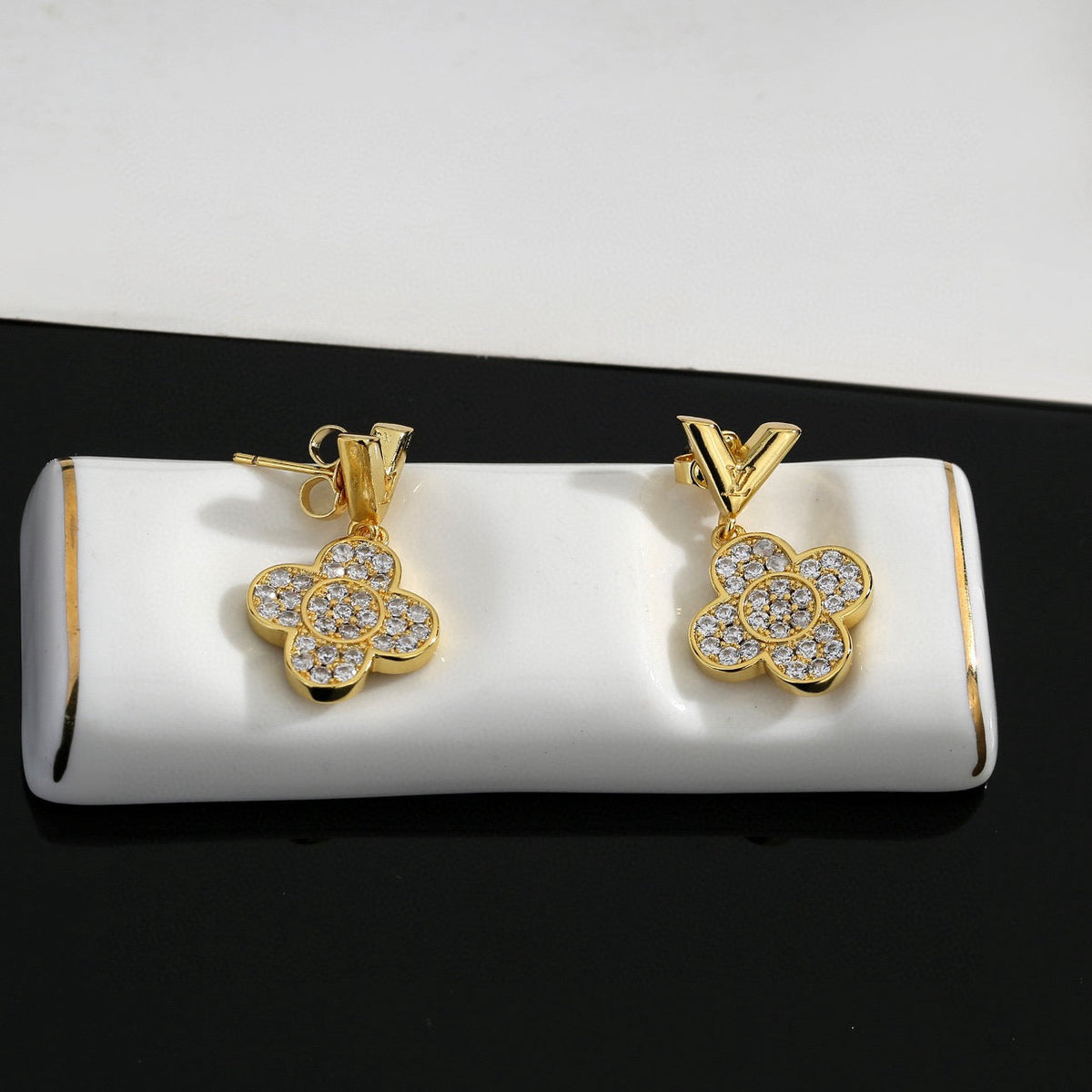Martin Graham stud earrings in polished metal-tone – close-up detail
