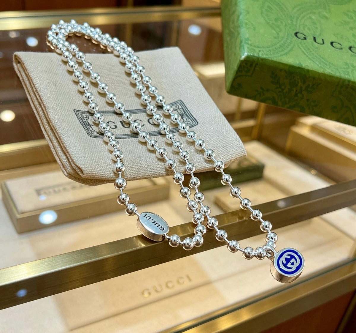 Martin Graham pendant necklace in polished metal-tone – close-up detail