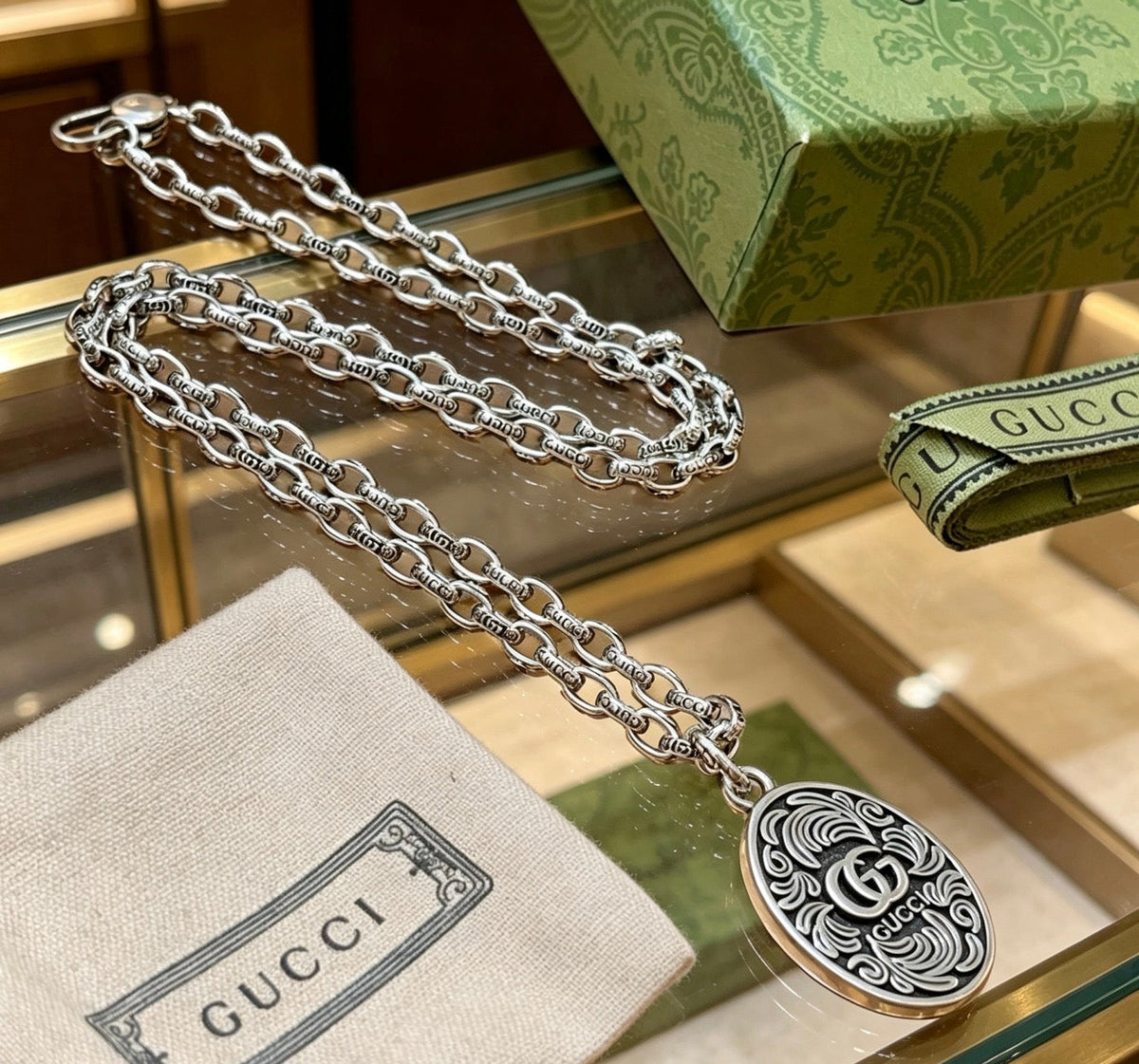 Martin Graham pendant necklace in polished metal-tone – close-up detail