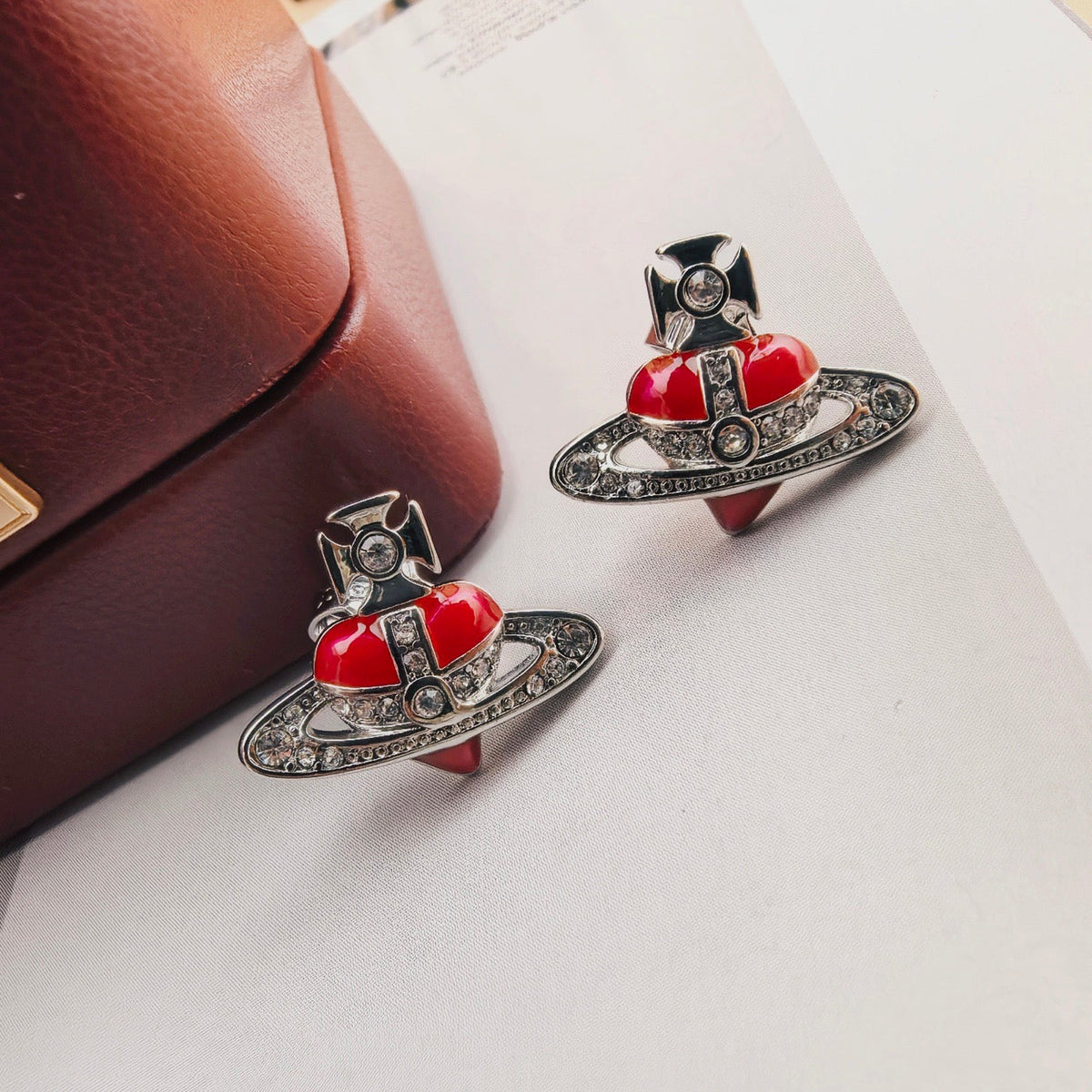 Martin Graham stud earrings in polished metal-tone – close-up detail