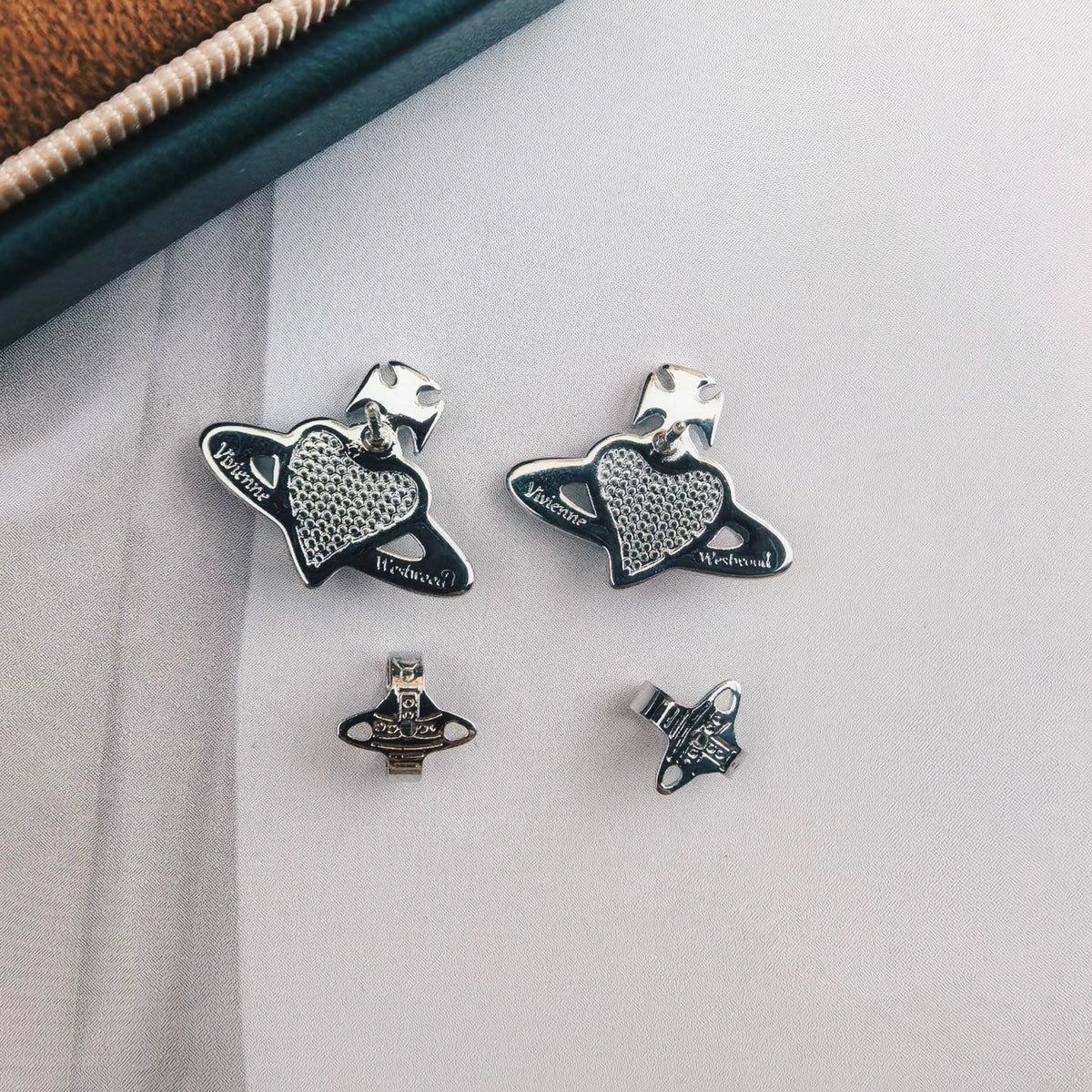 Martin Graham stud earrings in polished metal-tone – front product view