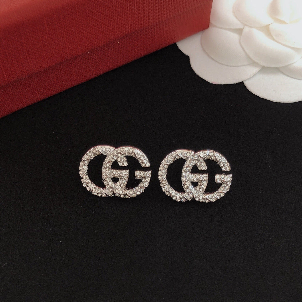 Martin Graham stud earrings in polished metal-tone – close-up detail