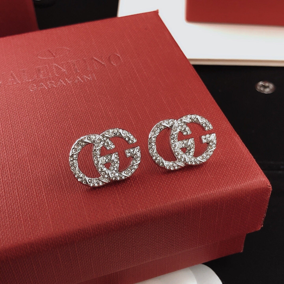 Martin Graham stud earrings in polished metal-tone – styled product view