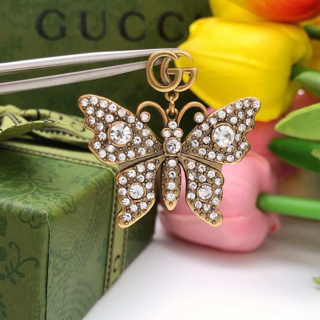 Martin Graham stud earrings in polished metal-tone – styled product view