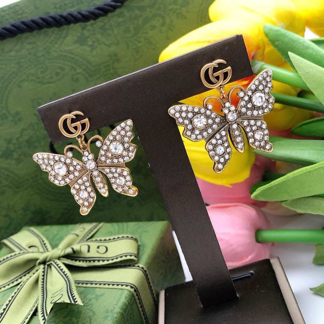 Martin Graham stud earrings in polished metal-tone – close-up detail