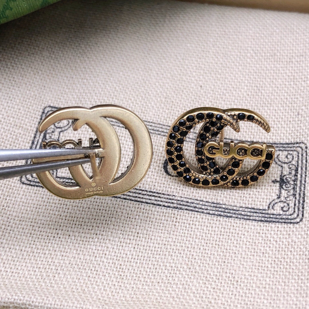 Martin Graham stud earrings in polished metal-tone – close-up detail