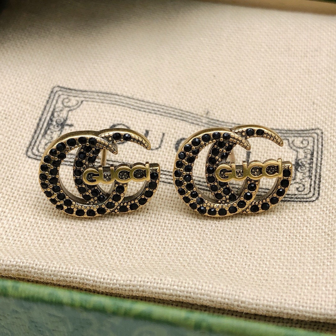 Martin Graham stud earrings in polished metal-tone – styled product view